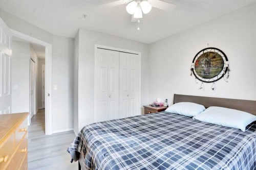 6211-304 Mackenzie Way Sw, Airdrie, AB - Indoor Photo Showing Bedroom