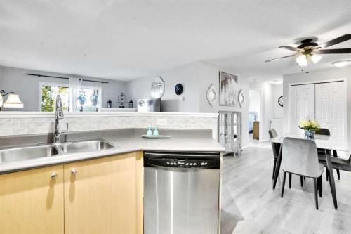 6211-304 Mackenzie Way Sw, Airdrie, AB - Indoor Photo Showing Kitchen With Double Sink