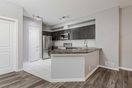 303-100 Cranfield Common Se, Calgary, AB - Indoor Photo Showing Kitchen With Upgraded Kitchen