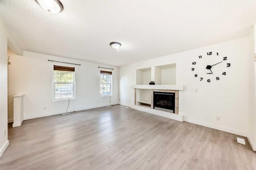 715 Copperfield Boulevard Se, Calgary, AB - Indoor Photo Showing Living Room With Fireplace