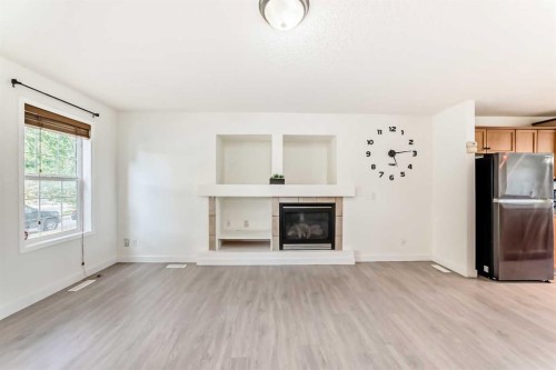 715 Copperfield Boulevard Se, Calgary, AB - Indoor Photo Showing Living Room With Fireplace