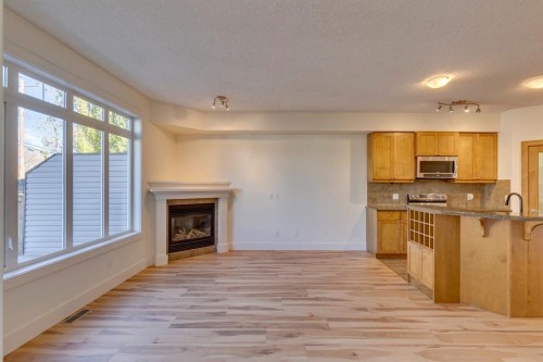 2340 24 Avenue Nw, Calgary, AB - Indoor Photo Showing Kitchen With Fireplace