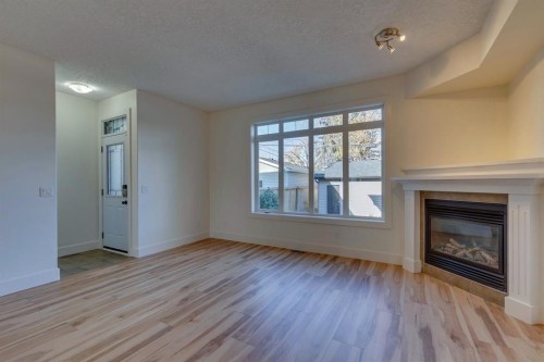 2340 24 Avenue Nw, Calgary, AB - Indoor Photo Showing Living Room With Fireplace
