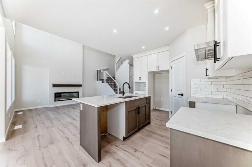 105 Corner Glen Green Ne, Calgary, AB - Indoor Photo Showing Kitchen With Fireplace