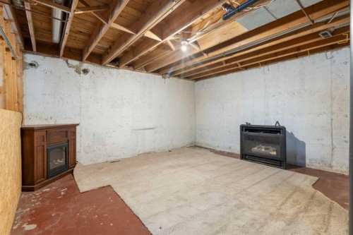 339 Ranchview Place Nw, Calgary, AB - Indoor Photo Showing Basement With Fireplace