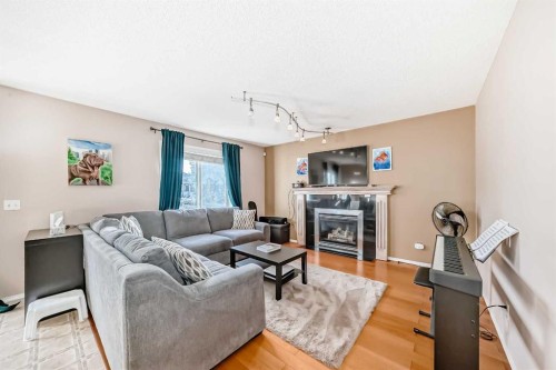 238 Bridleridge Way Sw, Calgary, AB - Indoor Photo Showing Living Room With Fireplace