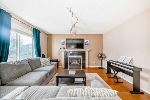238 Bridleridge Way Sw, Calgary, AB - Indoor Photo Showing Living Room With Fireplace