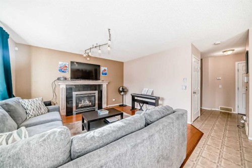 238 Bridleridge Way Sw, Calgary, AB - Indoor Photo Showing Living Room With Fireplace