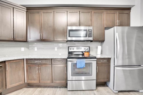 102-3 Taracove Estate Drive Ne, Calgary, AB - Indoor Photo Showing Kitchen With Stainless Steel Kitchen
