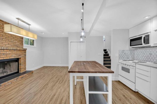 91 Shawglen Way Sw, Calgary, AB - Indoor Photo Showing Kitchen With Fireplace