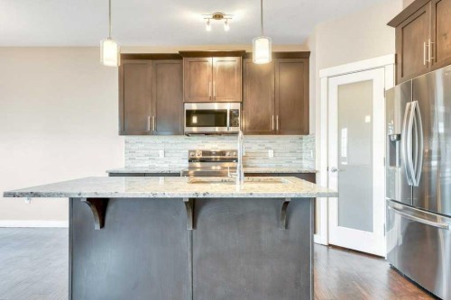 2450 Baysprings Link Sw, Airdrie, AB - Indoor Photo Showing Kitchen With Upgraded Kitchen