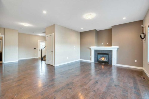 2450 Baysprings Link Sw, Airdrie, AB - Indoor Photo Showing Living Room With Fireplace