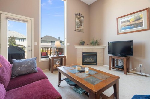 122 Bridlewood Lane Sw, Calgary, AB - Indoor Photo Showing Living Room With Fireplace