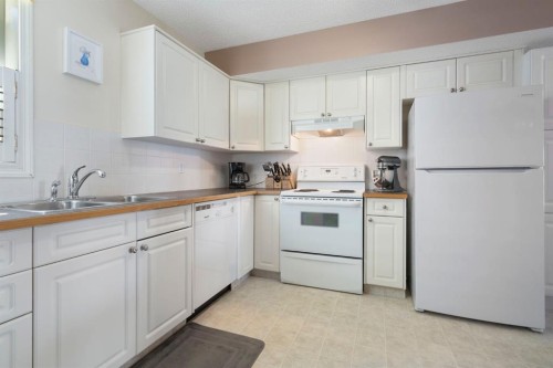 122 Bridlewood Lane Sw, Calgary, AB - Indoor Photo Showing Kitchen With Double Sink