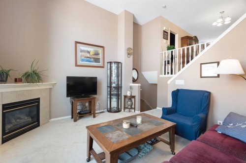 122 Bridlewood Lane Sw, Calgary, AB - Indoor Photo Showing Living Room With Fireplace