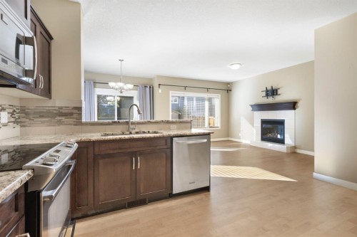 328 Silverado Plains Circle Sw, Calgary, AB - Indoor Photo Showing Kitchen With Fireplace