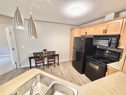 116-369 Rocky Vista Park Nw, Calgary, AB - Indoor Photo Showing Kitchen With Double Sink