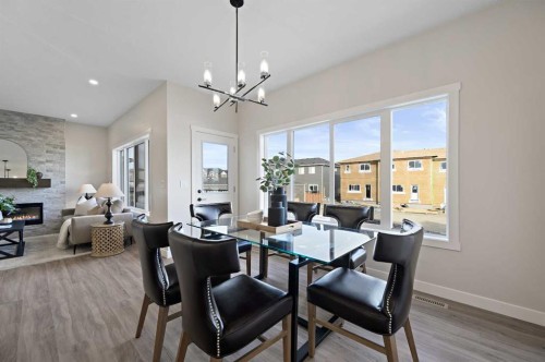 634 Bayview Lane Sw, Airdrie, AB - Indoor Photo Showing Dining Room With Fireplace