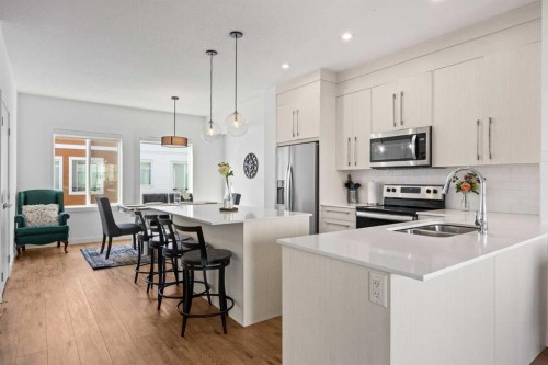 602-335 Creekside Boulevard Sw, Calgary, AB - Indoor Photo Showing Kitchen With Double Sink With Upgraded Kitchen