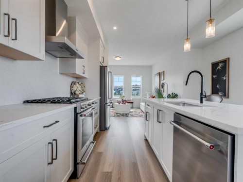 1306-200 Southridge Drive, Okotoks, AB - Indoor Photo Showing Kitchen With Stainless Steel Kitchen With Upgraded Kitchen