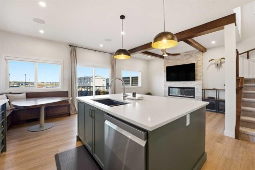 16 Key Cove Sw, Airdrie, AB - Indoor Photo Showing Kitchen With Fireplace With Double Sink With Upgraded Kitchen