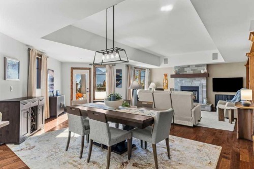 303-150 Stonecreek Road, Canmore, AB - Indoor Photo Showing Dining Room With Fireplace