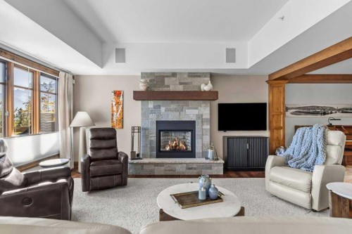 303-150 Stonecreek Road, Canmore, AB - Indoor Photo Showing Living Room With Fireplace
