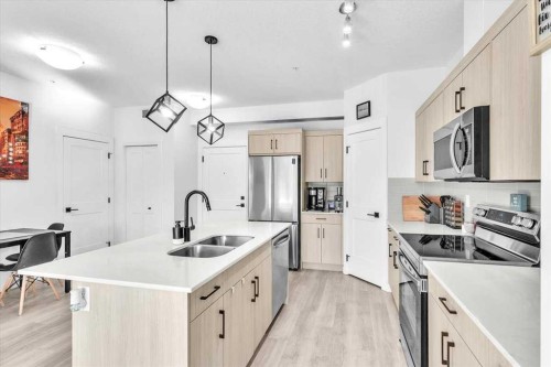 305-30 Sage Hill Walk Nw, Calgary, AB - Indoor Photo Showing Kitchen With Stainless Steel Kitchen With Double Sink With Upgraded Kitchen