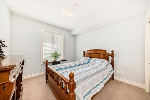 3104-15 Sunset Square, Cochrane, AB - Indoor Photo Showing Bedroom