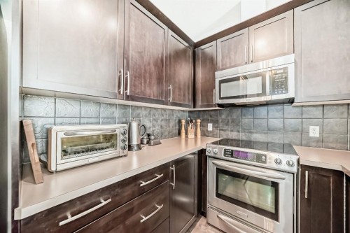 3104-15 Sunset Square, Cochrane, AB - Indoor Photo Showing Kitchen