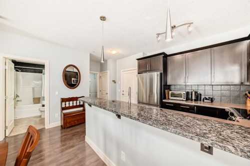 3104-15 Sunset Square, Cochrane, AB - Indoor Photo Showing Kitchen With Upgraded Kitchen