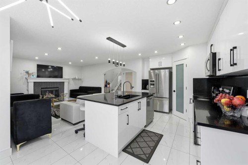 53 Martha'S Place Ne, Calgary, AB - Indoor Photo Showing Kitchen With Fireplace With Upgraded Kitchen