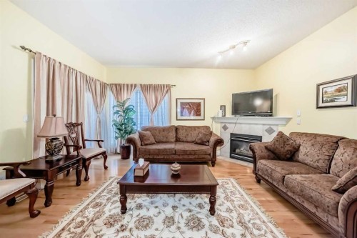 187 Bridlewood View Sw, Calgary, AB - Indoor Photo Showing Living Room With Fireplace