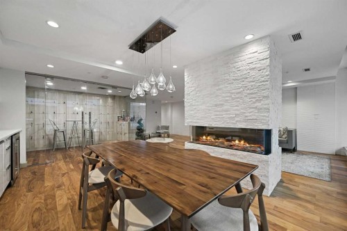2402-1234 5 Avenue Nw, Calgary, AB - Indoor Photo Showing Dining Room With Fireplace