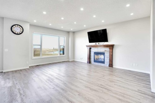 85 Boulder Creek Manor Se, Langdon, AB - Indoor Photo Showing Living Room With Fireplace
