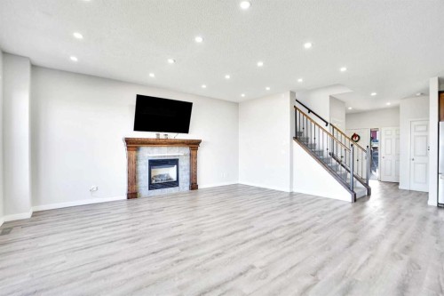 85 Boulder Creek Manor Se, Langdon, AB - Indoor Photo Showing Other Room With Fireplace