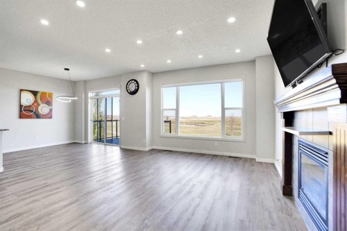 85 Boulder Creek Manor Se, Langdon, AB - Indoor Photo Showing Living Room With Fireplace