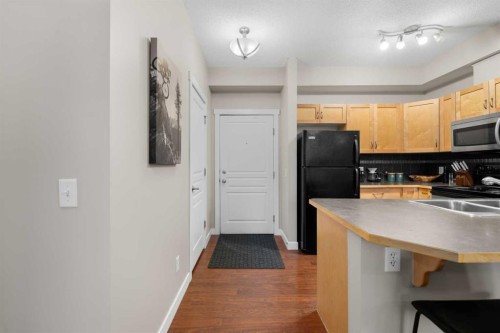 1111-211 Aspen Stone Boulevard Sw, Calgary, AB - Indoor Photo Showing Kitchen With Double Sink