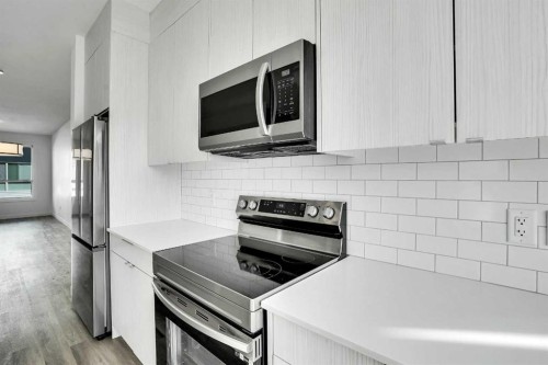105 Panatella Square Nw, Calgary, AB - Indoor Photo Showing Kitchen With Stainless Steel Kitchen With Upgraded Kitchen