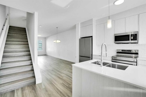 105 Panatella Square Nw, Calgary, AB - Indoor Photo Showing Kitchen With Double Sink With Upgraded Kitchen