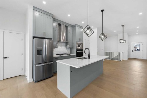 27 Wolf Crescent, Okotoks, AB - Indoor Photo Showing Kitchen With Double Sink With Upgraded Kitchen