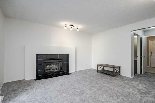 8 Millbank Road Sw, Calgary, AB - Indoor Photo Showing Living Room With Fireplace