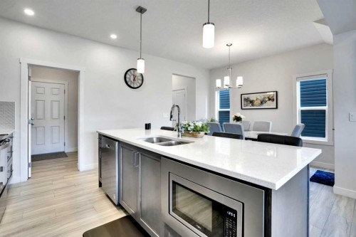 1457 Bayview Point Sw, Airdrie, AB - Indoor Photo Showing Kitchen With Double Sink