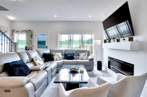 1457 Bayview Point Sw, Airdrie, AB - Indoor Photo Showing Living Room With Fireplace