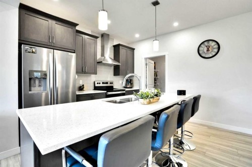 1457 Bayview Point Sw, Airdrie, AB - Indoor Photo Showing Kitchen With Stainless Steel Kitchen With Double Sink With Upgraded Kitchen