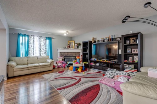 47 Westmount Road, Okotoks, AB - Indoor Photo Showing Living Room With Fireplace