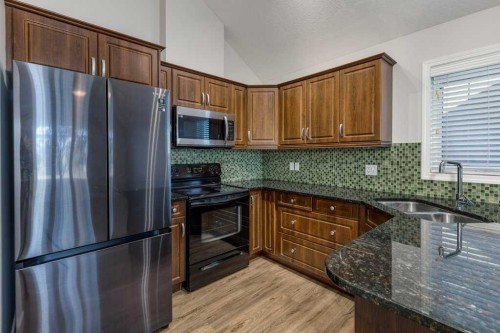 13-24 River Heights View, Cochrane, AB - Indoor Photo Showing Kitchen With Double Sink