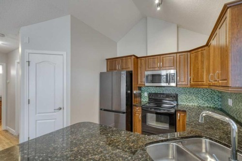 13-24 River Heights View, Cochrane, AB - Indoor Photo Showing Kitchen With Double Sink
