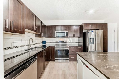1312-755 Copperpond Boulevard Se, Calgary, AB - Indoor Photo Showing Kitchen With Double Sink With Upgraded Kitchen