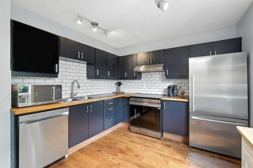 123 Silverstone Road Nw, Calgary, AB - Indoor Photo Showing Kitchen With Stainless Steel Kitchen With Double Sink